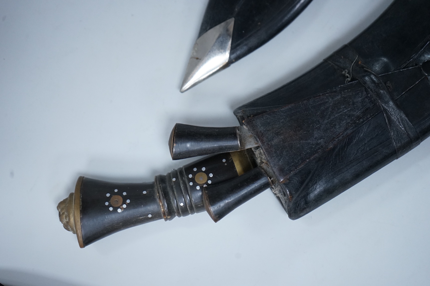 Two kukri knives in leather covered scabbards